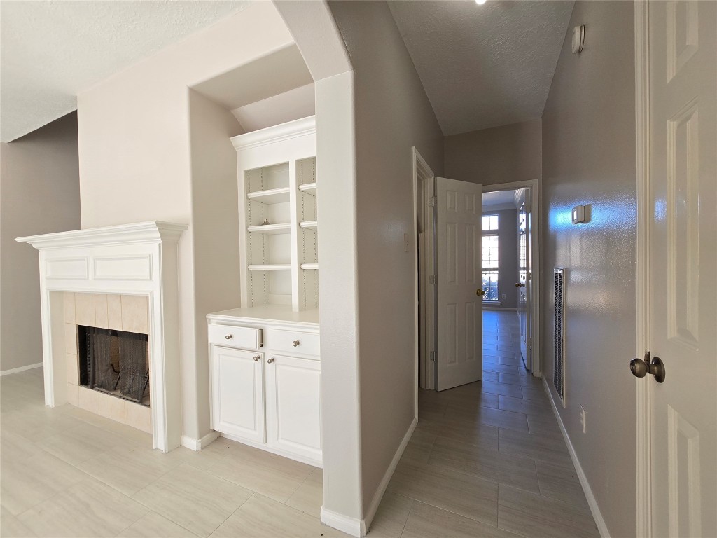 18819 Harbor Key Circle Houston, TX 77084 - Photo 7 of 33 a view of a hallway with windows and a fireplace