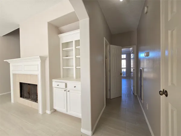 a view of a hallway with windows and a fireplace