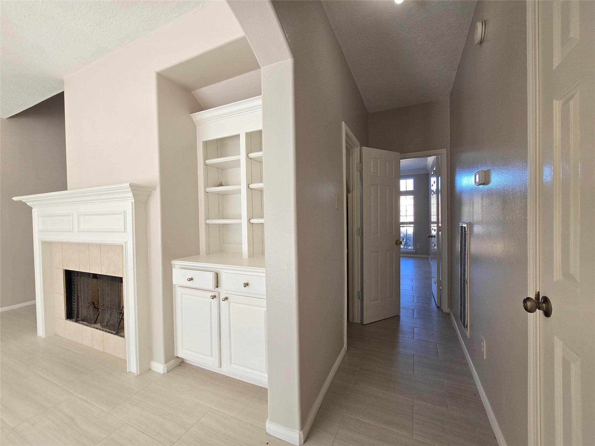 18819 Harbor Key Circle Houston, TX 77084 - Photo 7 of 33 a view of a hallway with windows and a fireplace