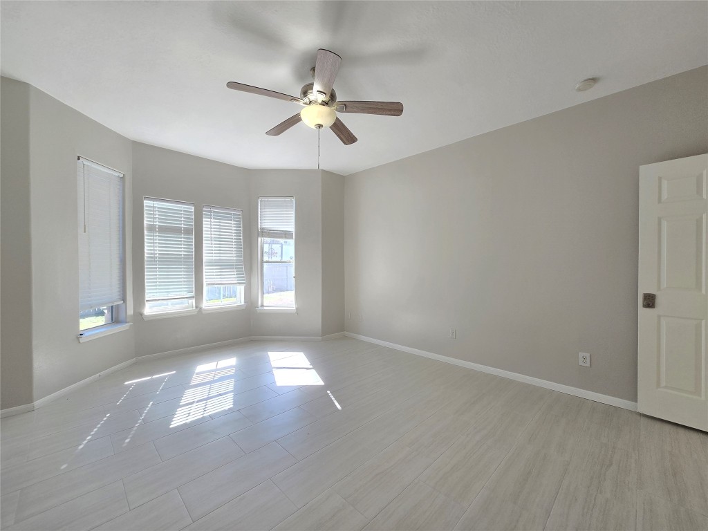 18819 Harbor Key Circle Houston, TX 77084 - Photo 9 of 33 a view of an empty room with chandelier fan and fire place