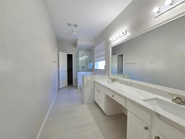 a large bathroom with a granite countertop sink and a mirror