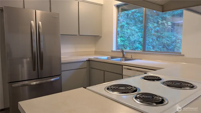 a kitchen with a refrigerator and a sink