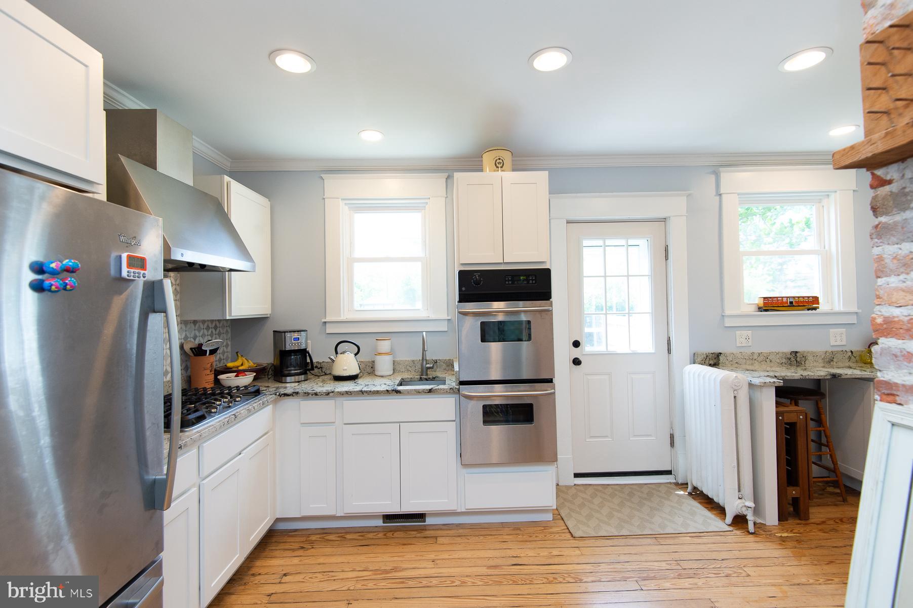 606 Locust Street Cambridge, MD 21613 - Photo 14 of 37 a kitchen with stainless steel appliances a refrigerator sink and microwave