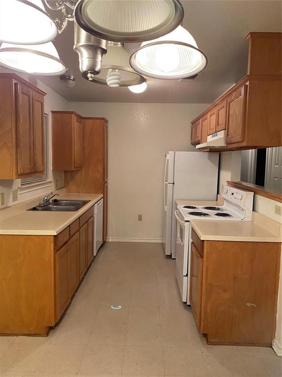 1518 Cherry Street Gainesville, TX 76240 - Photo 3 of 5 a kitchen with stainless steel appliances granite countertop a stove a sink and a microwave