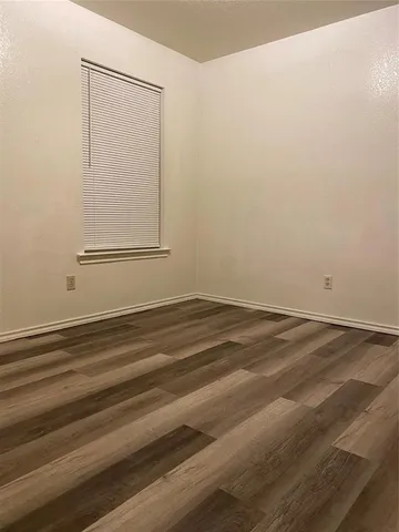 a view of a room with wooden floor and cabinet