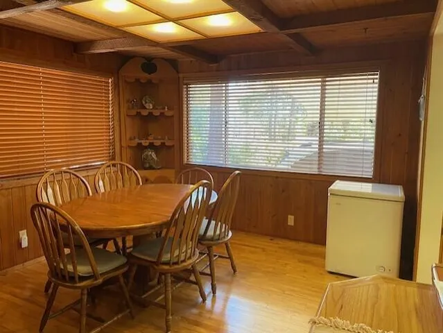 a view of a dining room with furniture and window