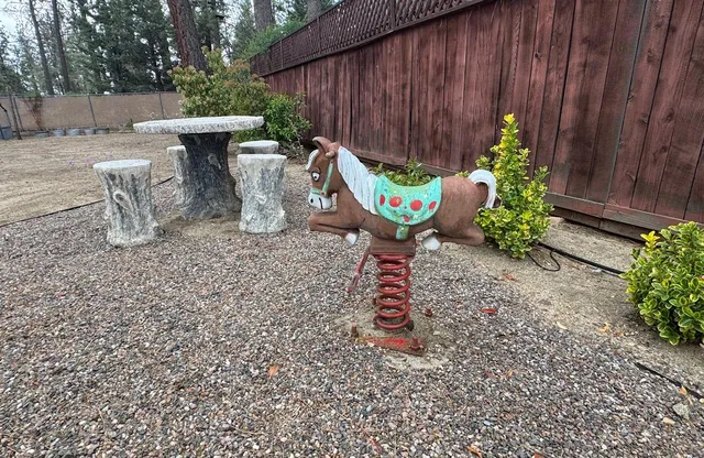 a table and chairs in a backyard of the house
