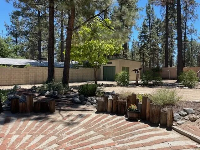 a view of a house with backyard and sitting area