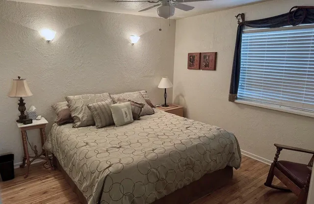 a bedroom with a bed and a window