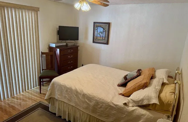 a bedroom with a bed and a tv