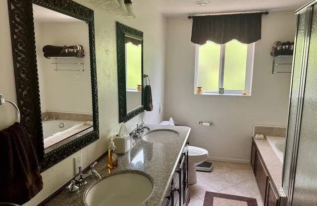 a bathroom with a sink vanity mirror and toilet