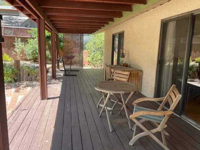 a view of a patio with table and chairs and wooden floor