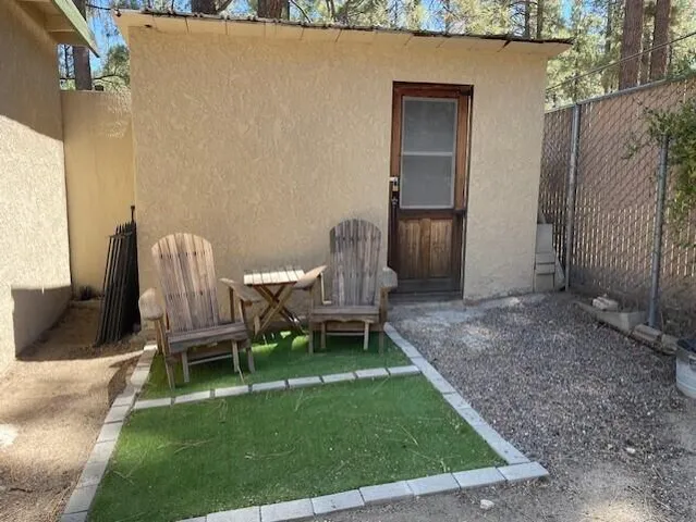 a view of a backyard with chairs and a table