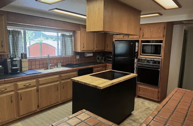 a kitchen with a sink stove and refrigerator