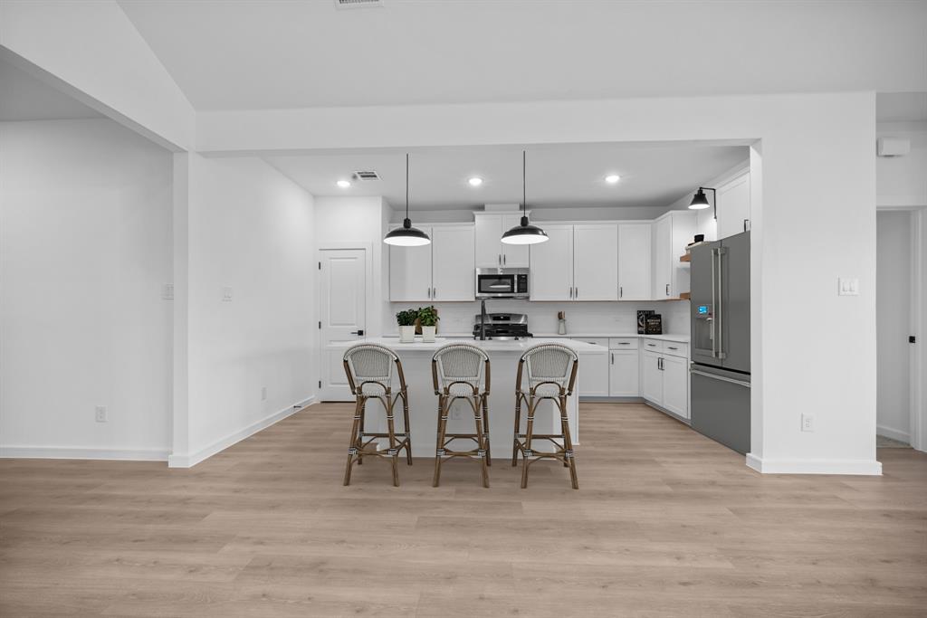 2209 Maple Ridge Drive Van Alstyne, TX 75495 - Photo 11 of 22 a view of kitchen with refrigerator and wooden floor