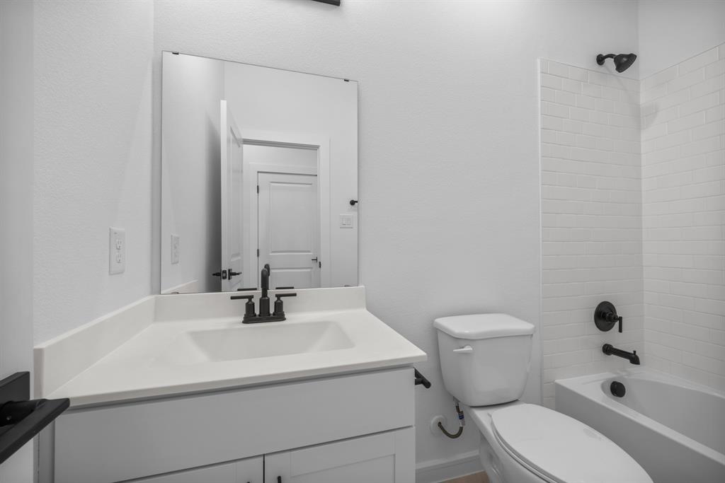 2209 Maple Ridge Drive Van Alstyne, TX 75495 - Photo 20 of 22 a bathroom with a sink toilet and shower