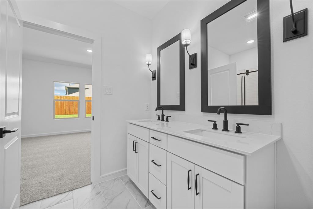 2209 Maple Ridge Drive Van Alstyne, TX 75495 - Photo 7 of 22 a bathroom with a double vanity sink and mirror