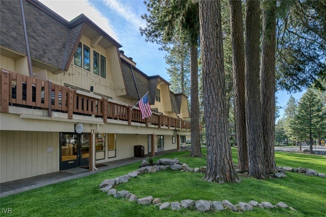 a view of a house with a yard and sitting area