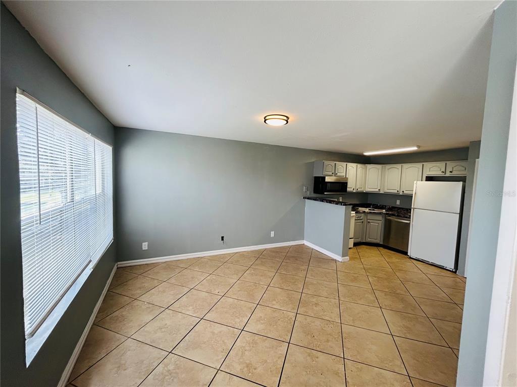 Undisclosed Address Orlando, FL 32811 - Photo 4 of 9 a view of a kitchen with microwave and cabinets