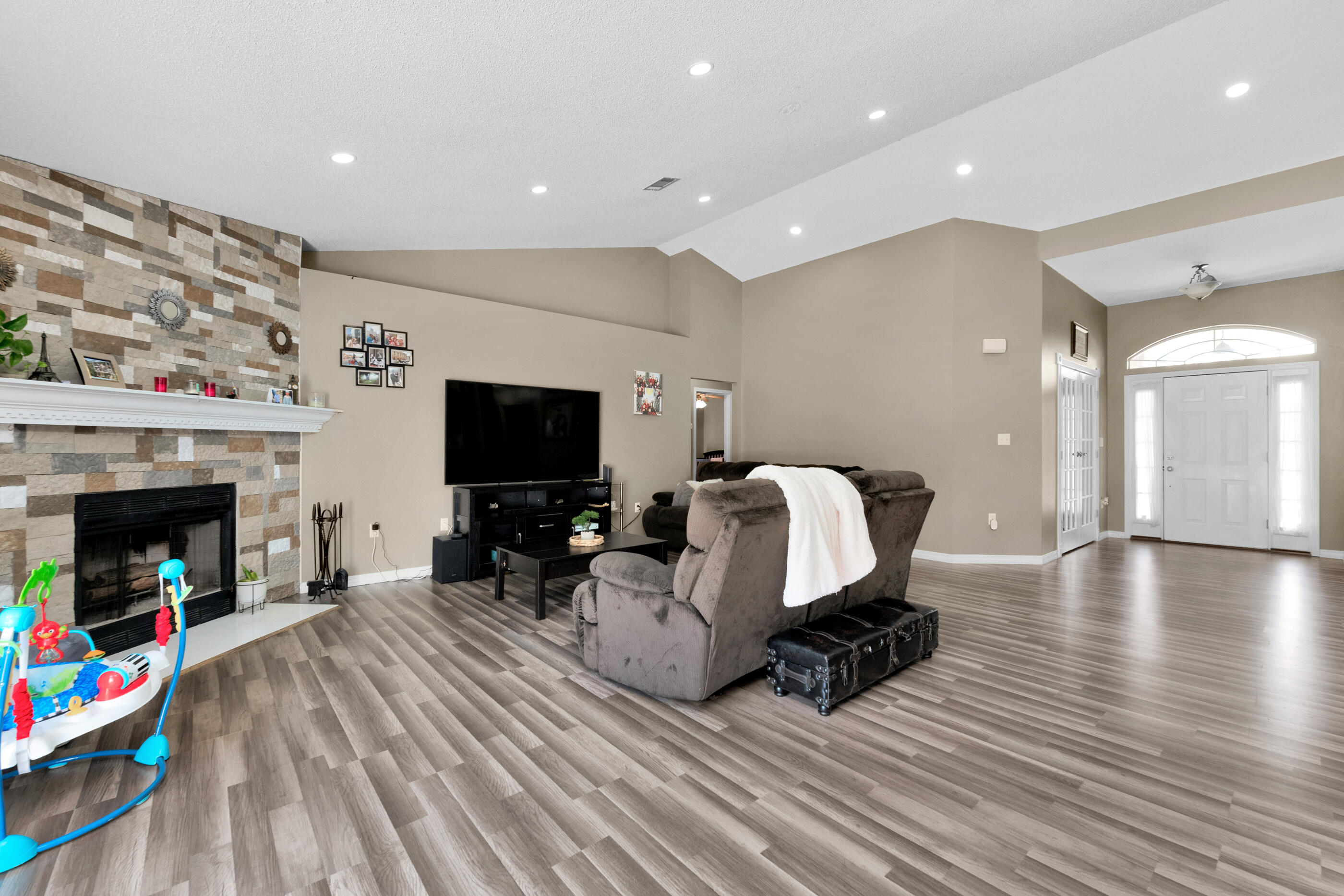 6215 Shire Lane Crestview, FL 32536 - Photo 11 of 36 a living room with furniture a flat screen tv and a fireplace