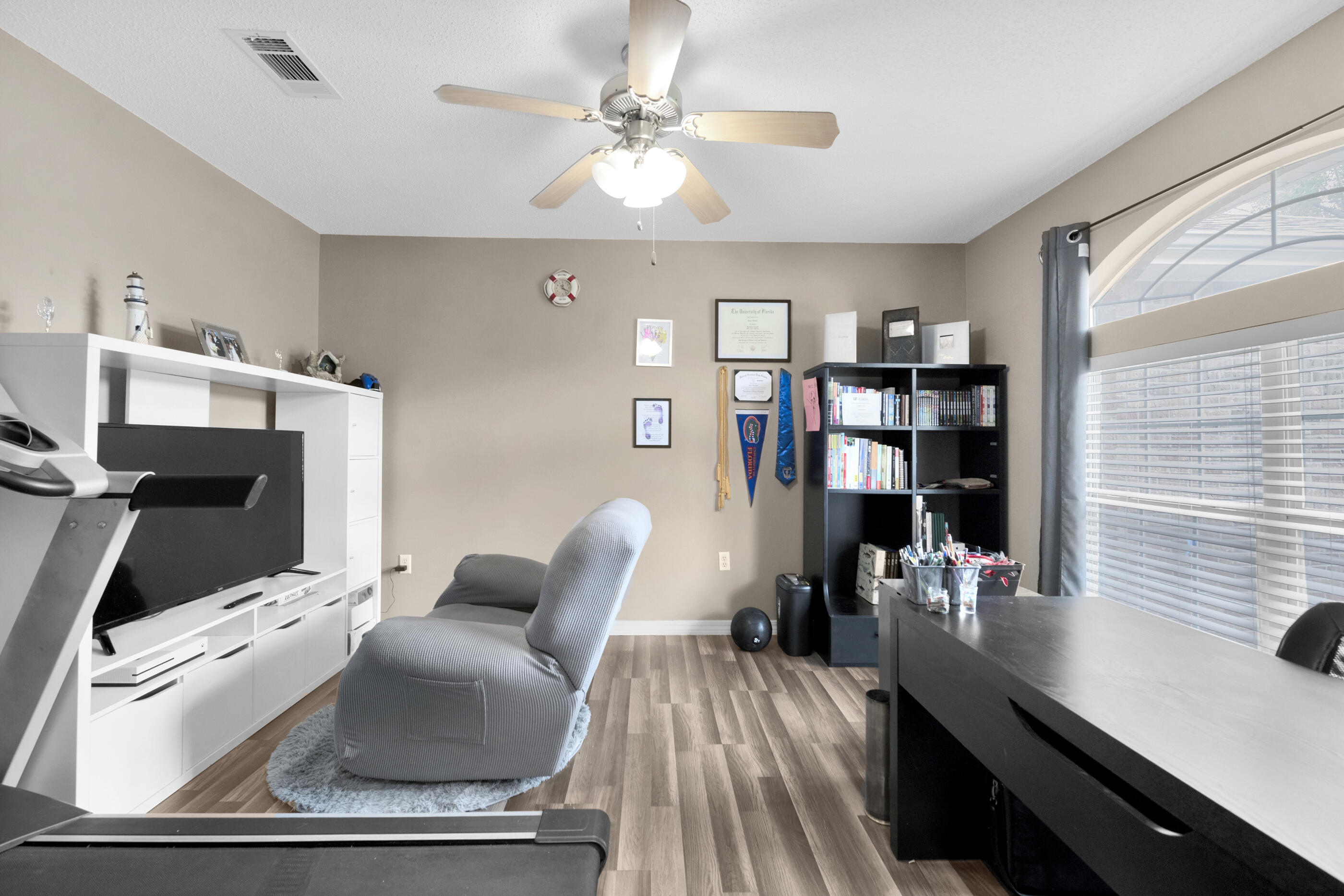 6215 Shire Lane Crestview, FL 32536 - Photo 15 of 36 a living room with furniture and a bookshelf