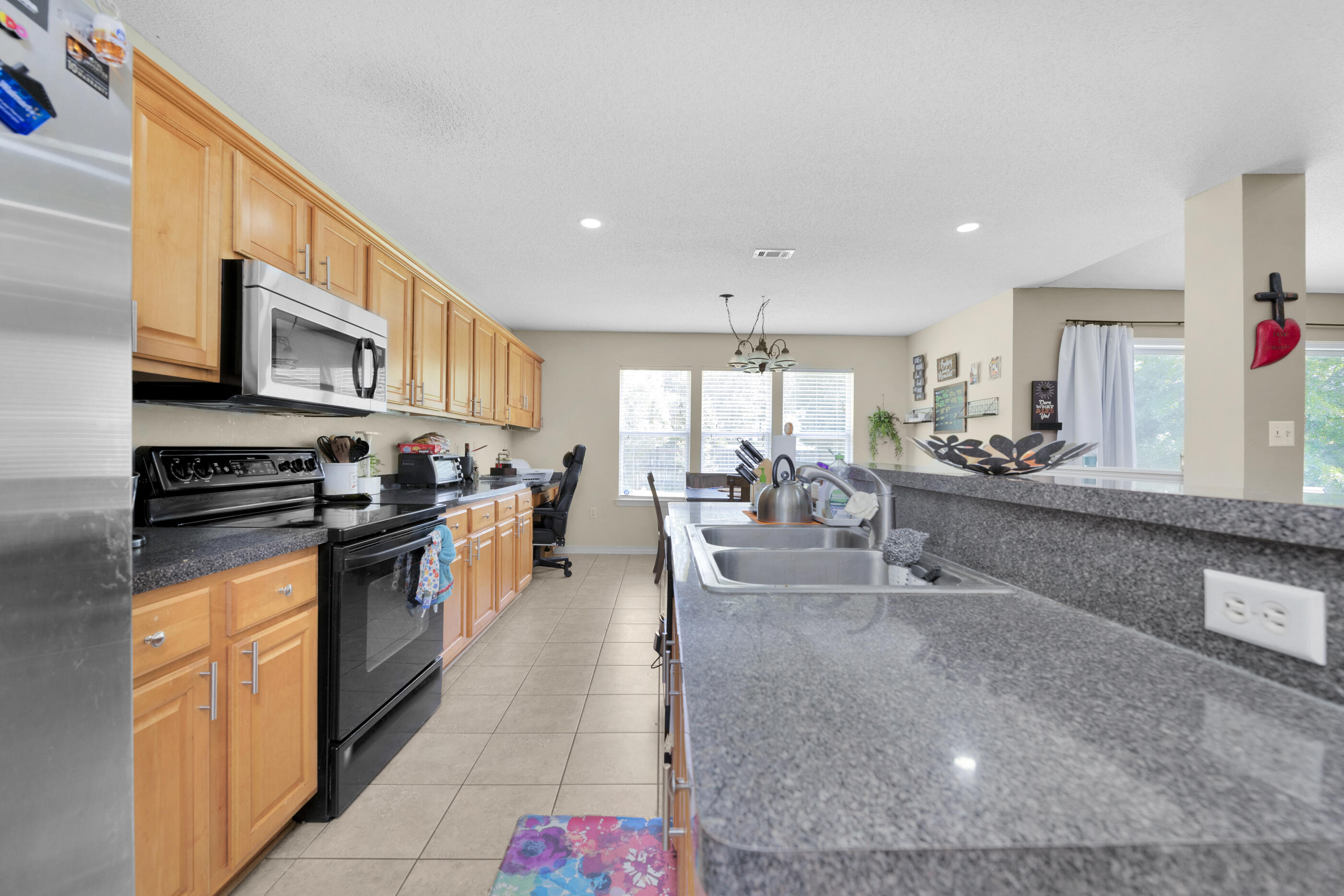 6215 Shire Lane Crestview, FL 32536 - Photo 16 of 36 a large white kitchen with stainless steel appliances