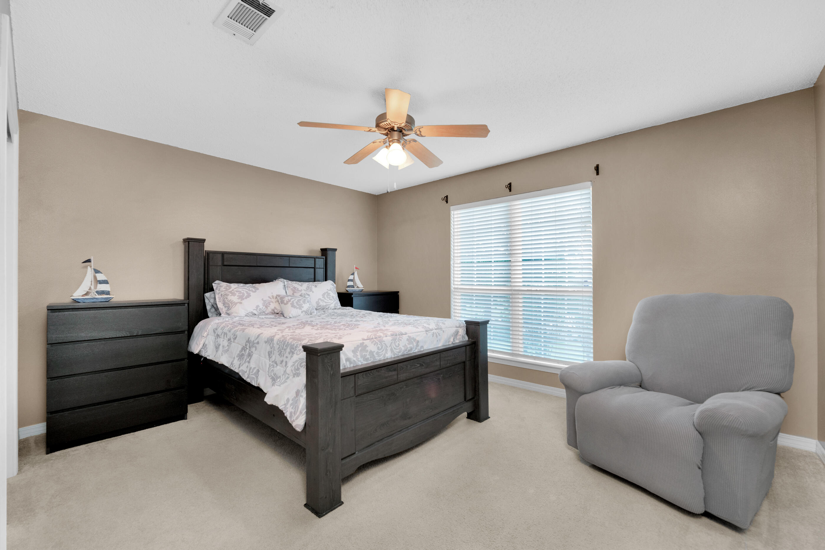 6215 Shire Lane Crestview, FL 32536 - Photo 19 of 36 a bedroom with bed couch and window