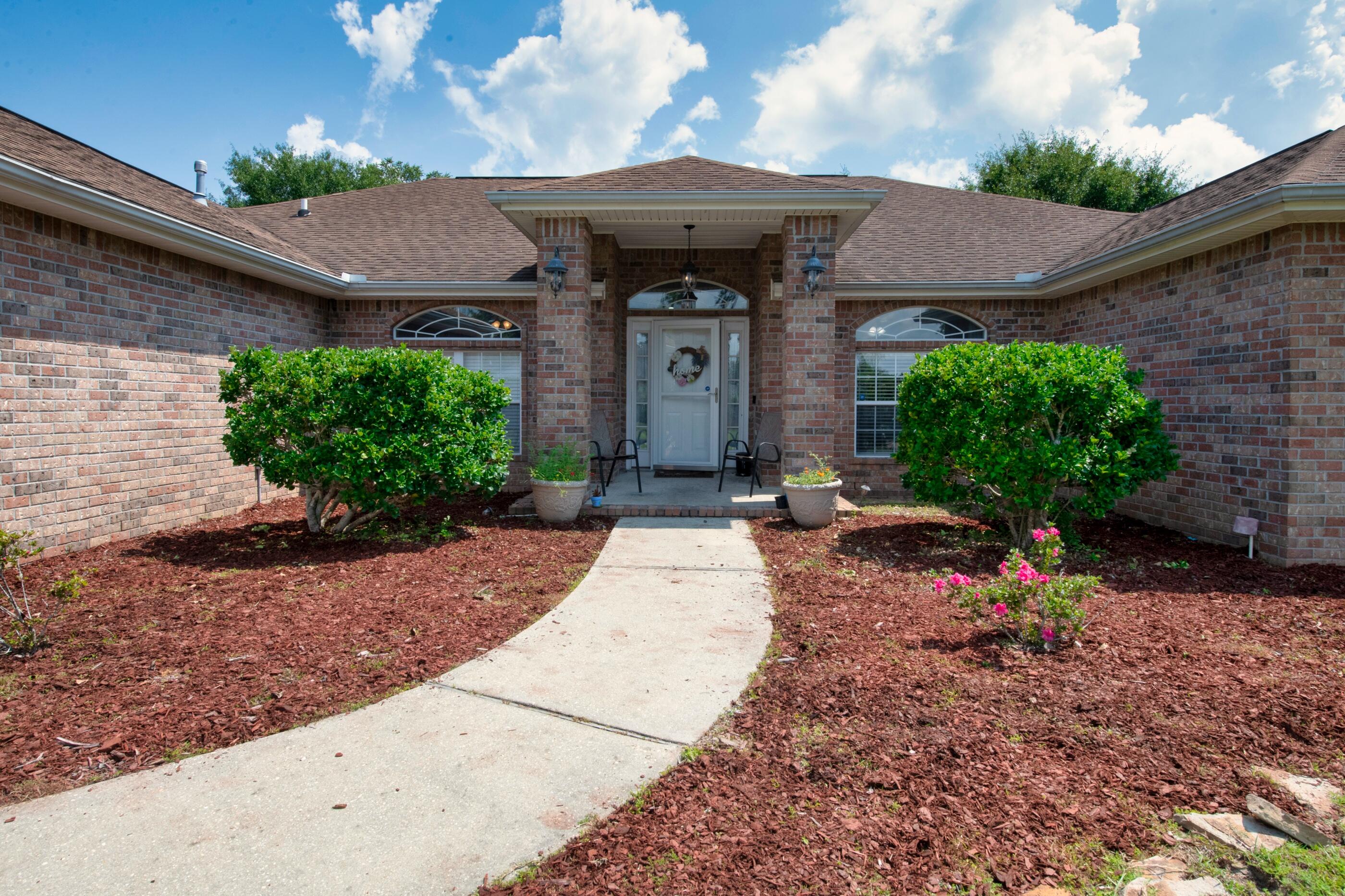 6215 Shire Lane Crestview, FL 32536 - Photo 2 of 36 a garden view with a seating space