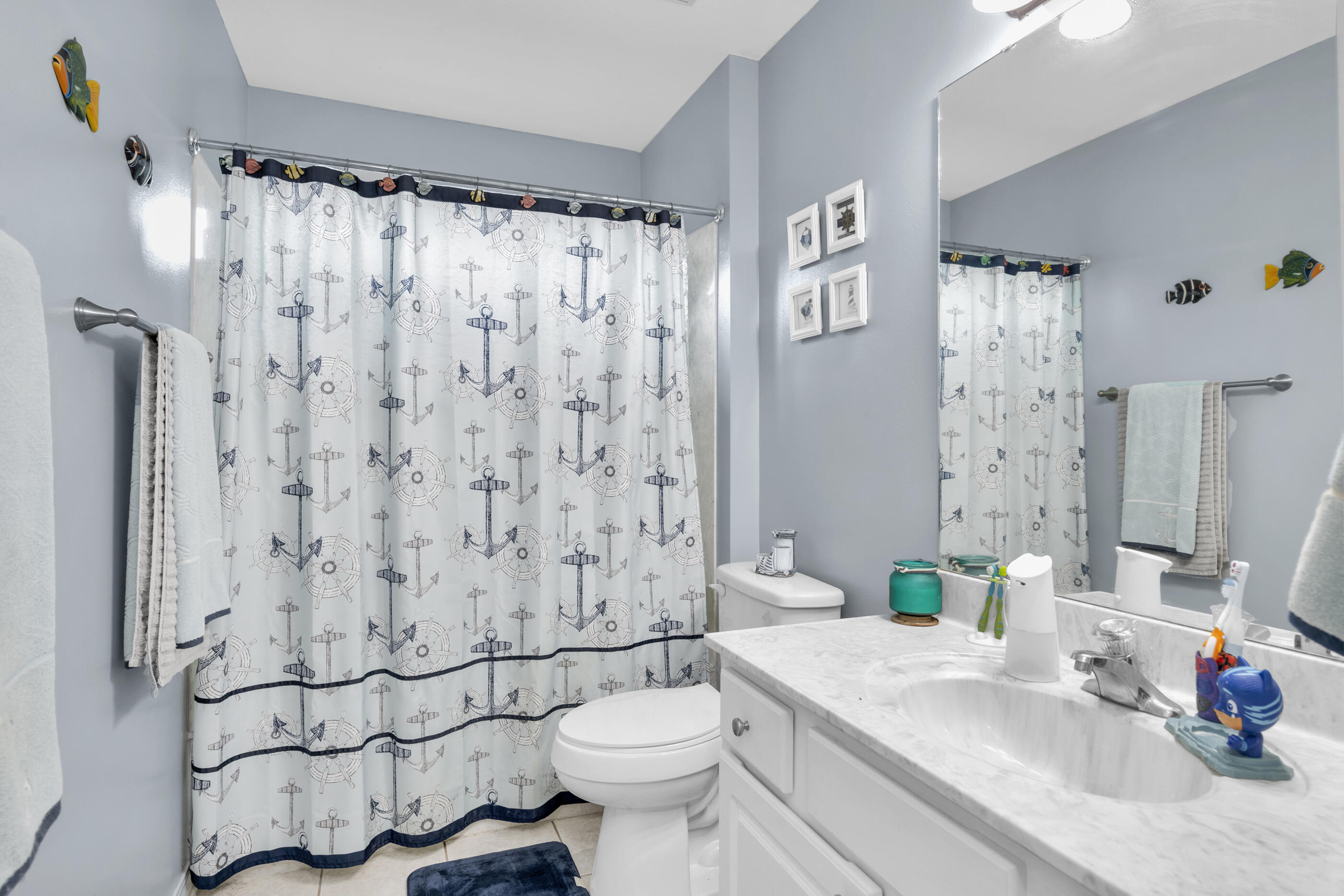 6215 Shire Lane Crestview, FL 32536 - Photo 21 of 36 a bathroom with a sink toilet and shower