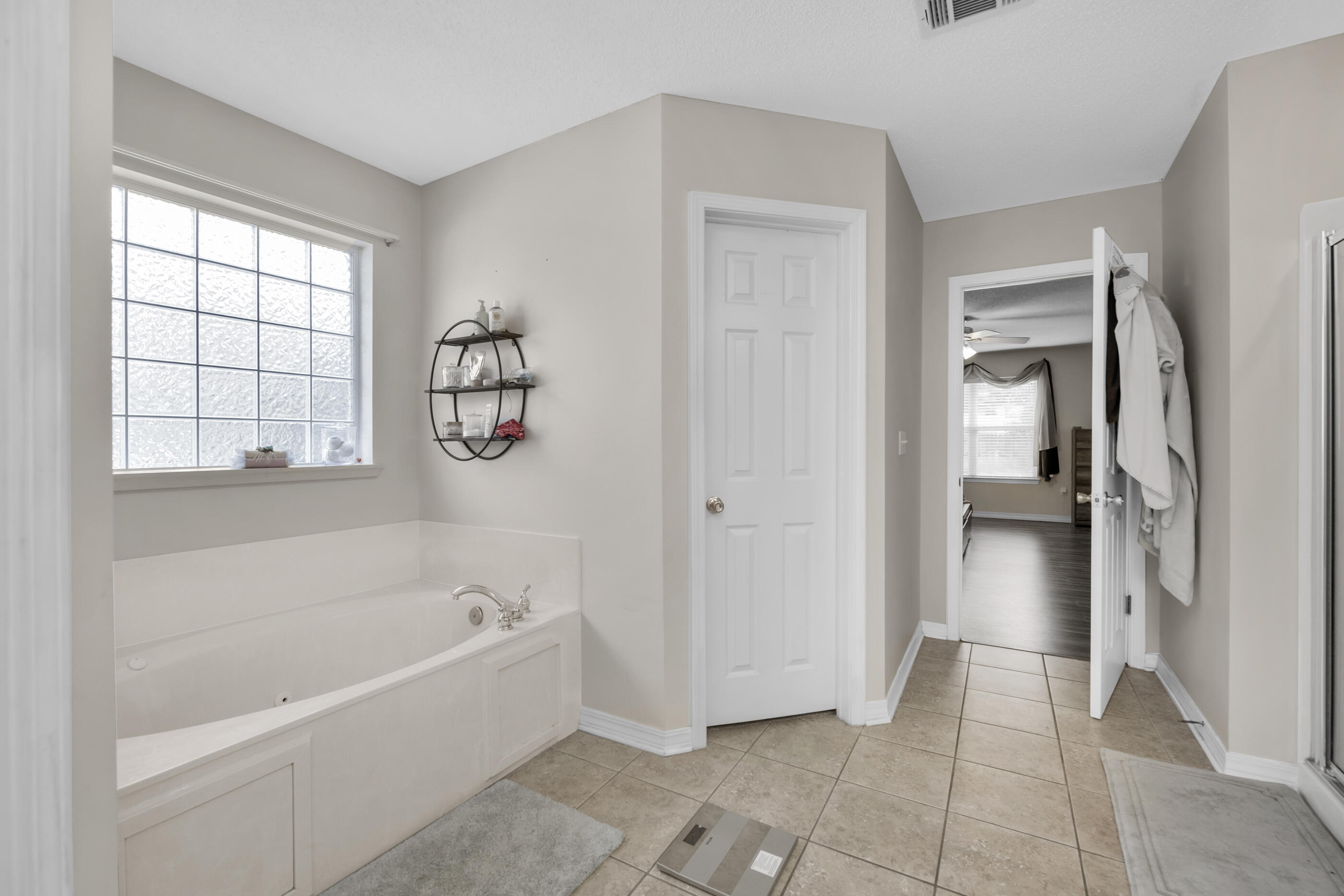 6215 Shire Lane Crestview, FL 32536 - Photo 27 of 36 a bathroom with a bathtub and a shower