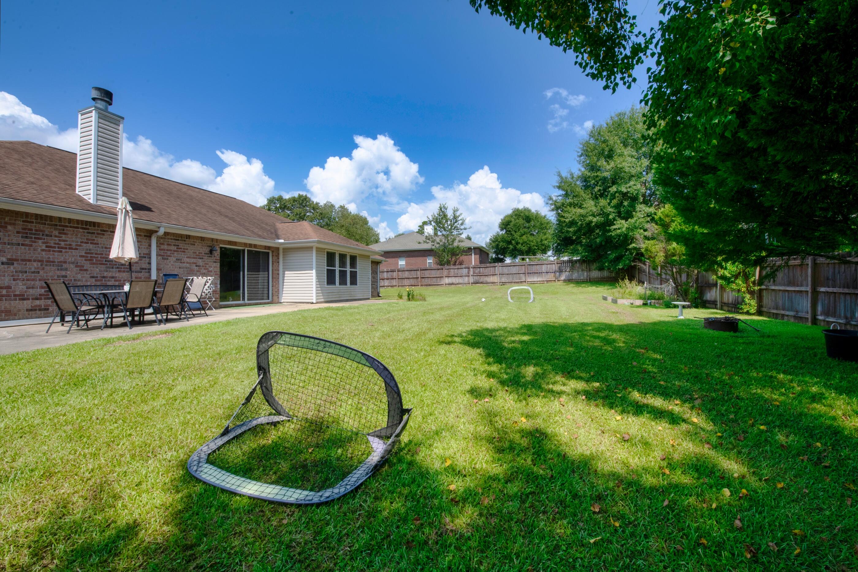 6215 Shire Lane Crestview, FL 32536 - Photo 29 of 36 a swimming pool with outdoor seating and yard