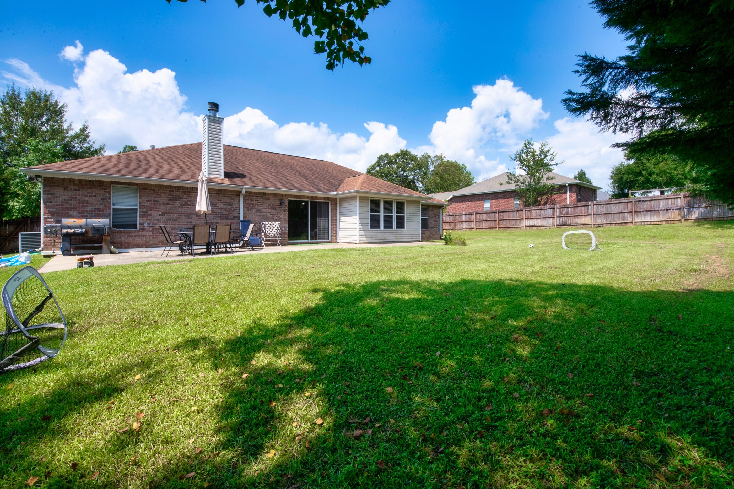 6215 Shire Lane Crestview, FL 32536 - Photo 30 of 36 a house view with a sitting space and garden