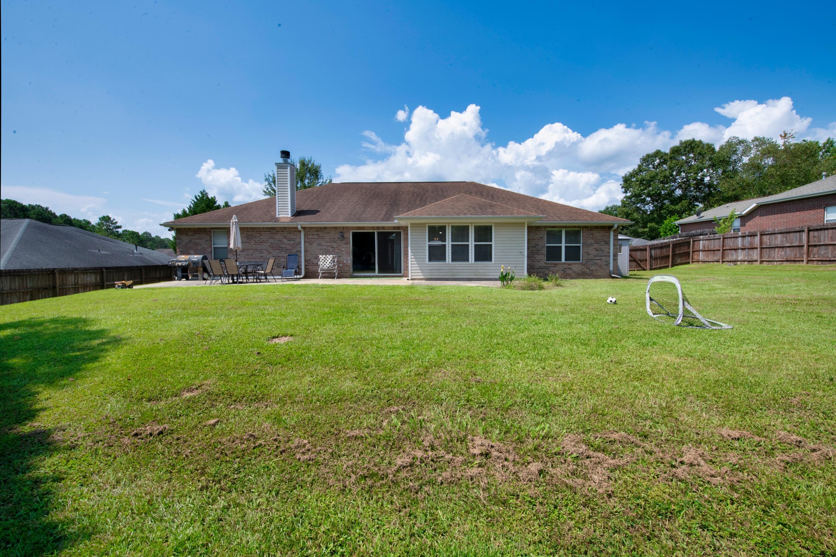 6215 Shire Lane Crestview, FL 32536 - Photo 31 of 36 a front view of a house with garden