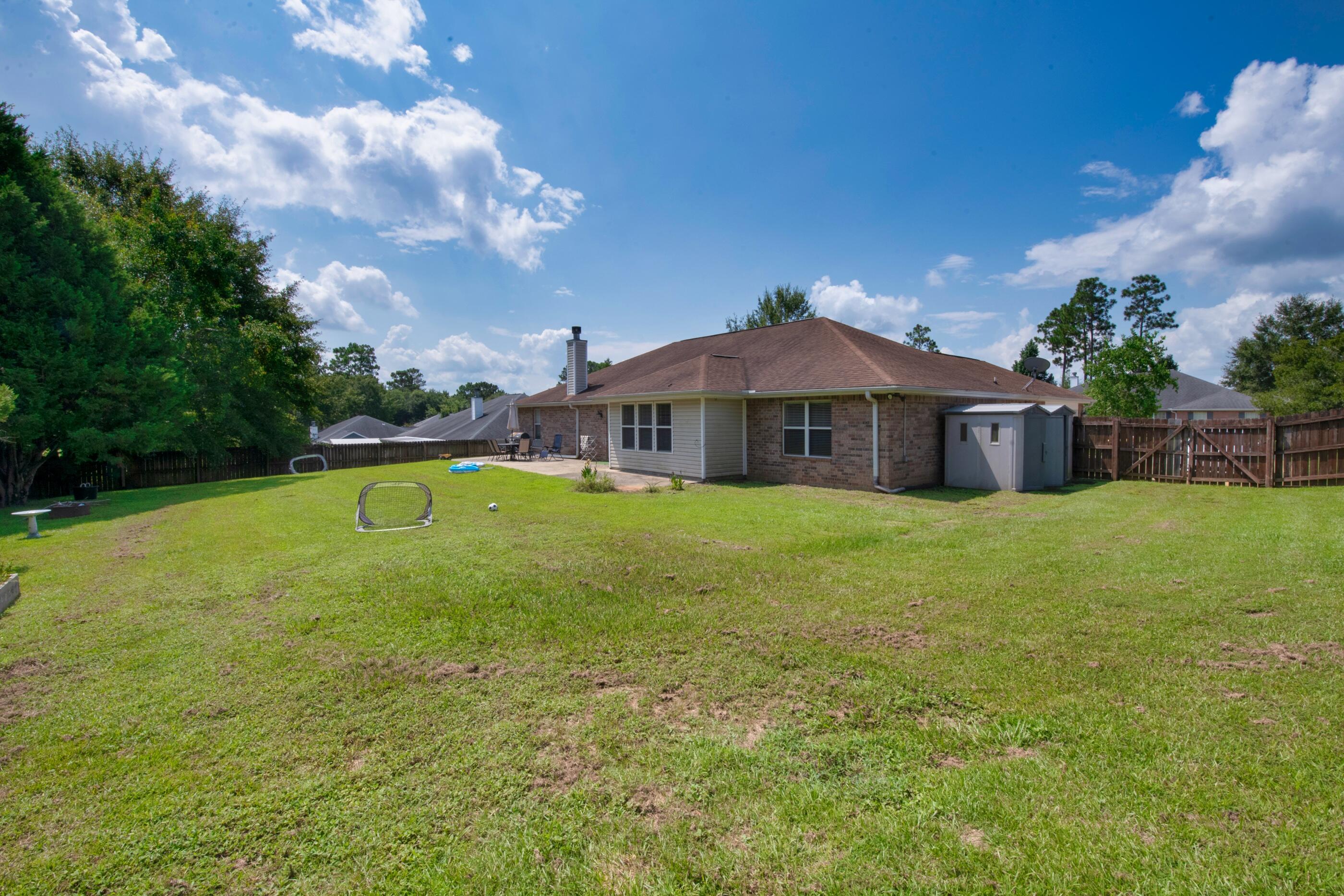 6215 Shire Lane Crestview, FL 32536 - Photo 32 of 36 a view of a house with a backyard
