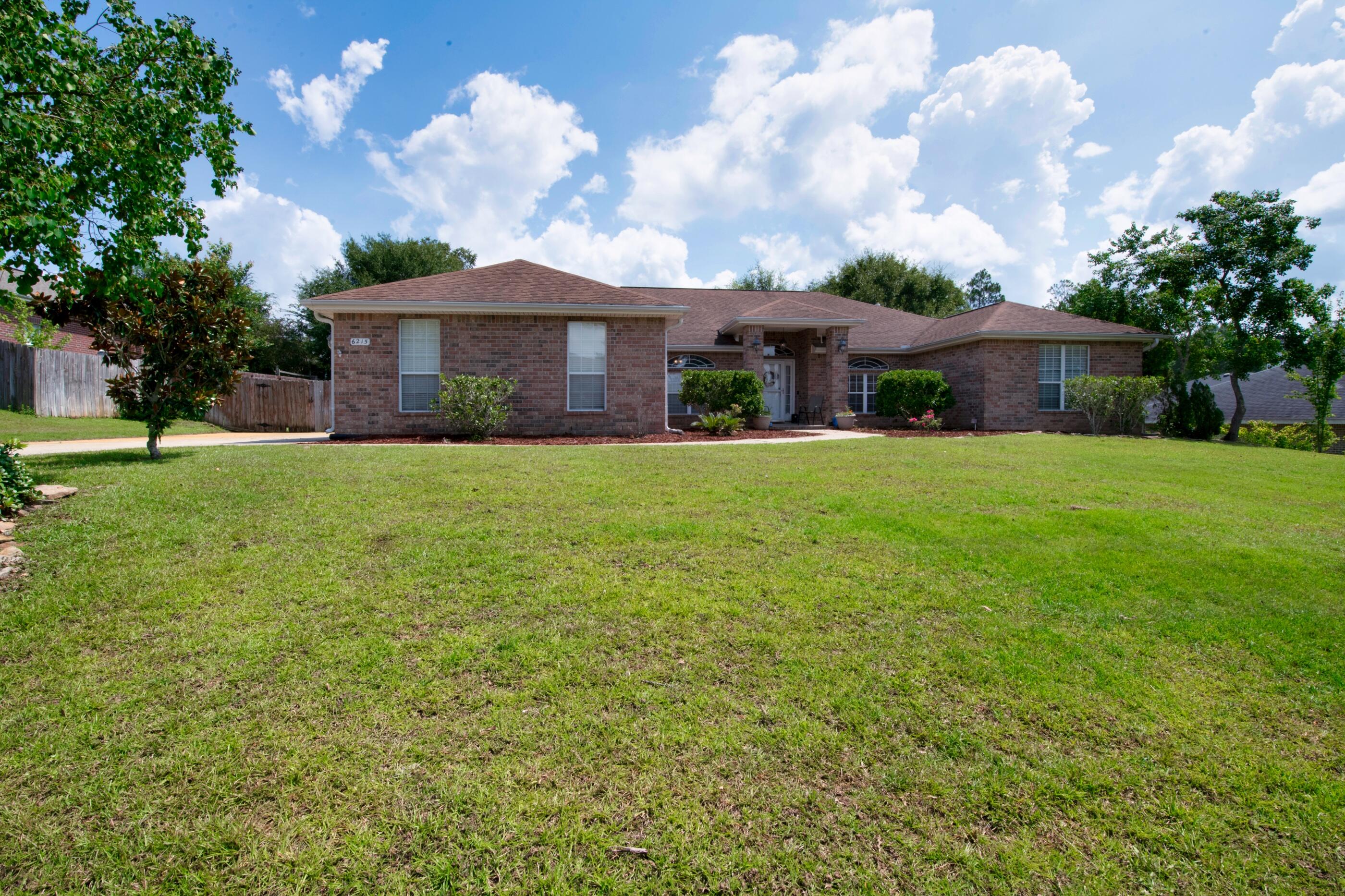 6215 Shire Lane Crestview, FL 32536 - Photo 4 of 36 a front view of a house with a garden