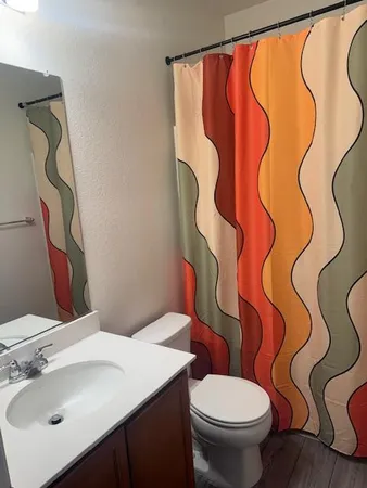 a bathroom with a sink toilet and a mirror