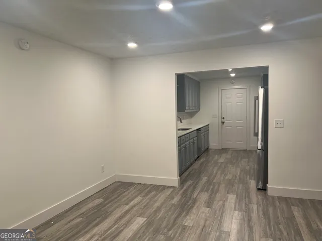a view of a kitchen with a sink and wooden floor