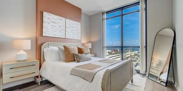 a bedroom with a large bed and a dresser