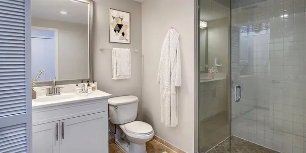 a bathroom with a sink toilet and shower