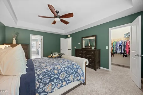 a living room with a bed and dresser