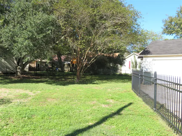 a view of backyard with swimming pool