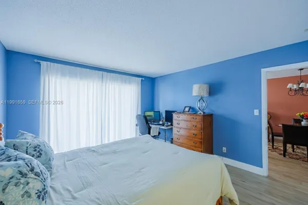 a bed room with a bed and a chair