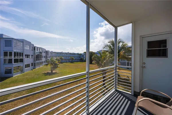 a view of balcony with floor to ceiling windows and pool table
