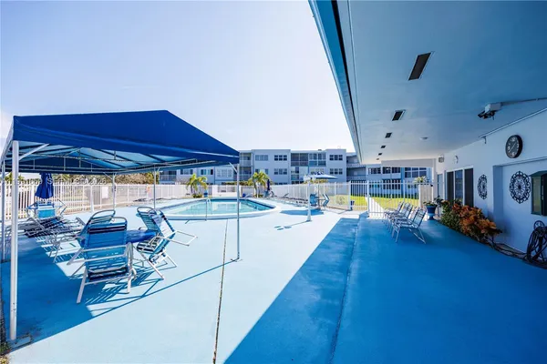 a swimming pool with outdoor seating and patio