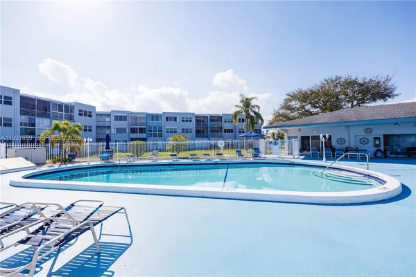 a view of pool with outdoor seating