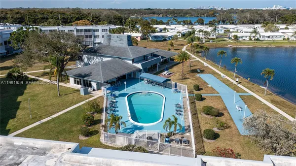 an aerial view of a house with a yard and lake view