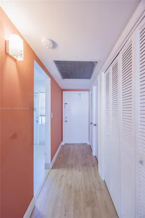 a view of hallway with wooden floor