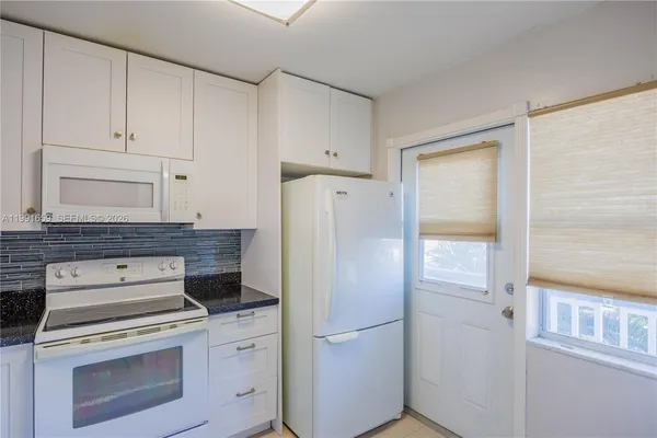 a kitchen with a stove and a refrigerator