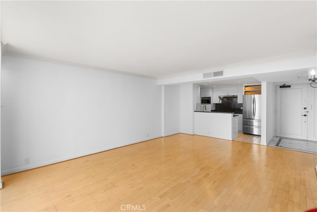 10535 Wilshire Boulevard, Unit 912 Los Angeles, CA 90024 - Photo 11 of 33 a view of a kitchen with wooden floor and a refrigerator