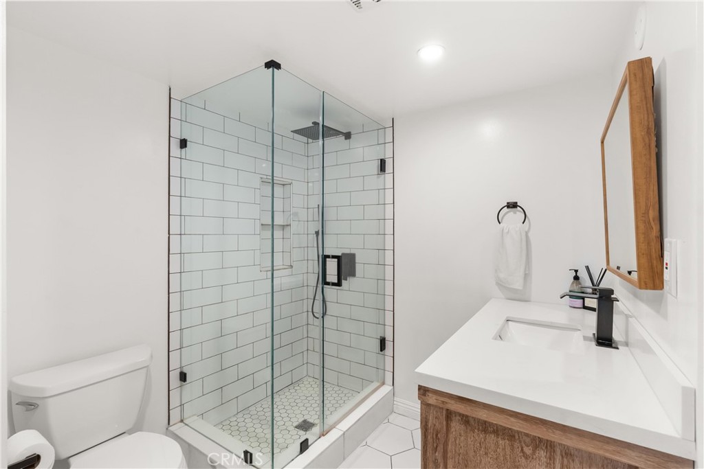 10535 Wilshire Boulevard, Unit 912 Los Angeles, CA 90024 - Photo 29 of 33 a bathroom with a sink toilet and shower